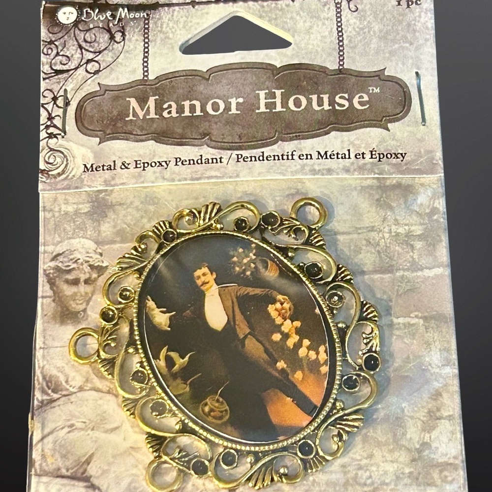 2008 Blue Moon Beads “Manor House” metal pendant; gold tone; magician